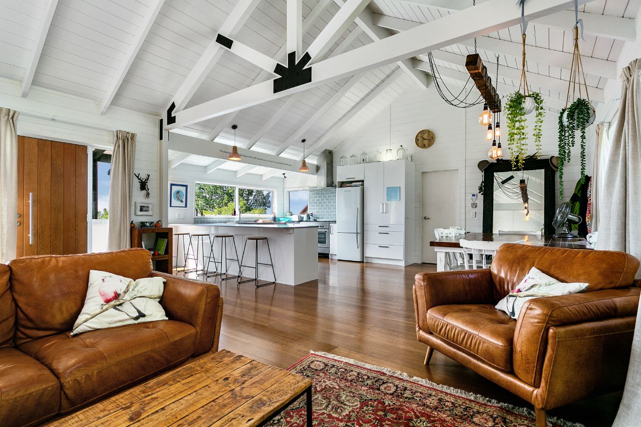 Warm timber and linen villa interior with leather sofas